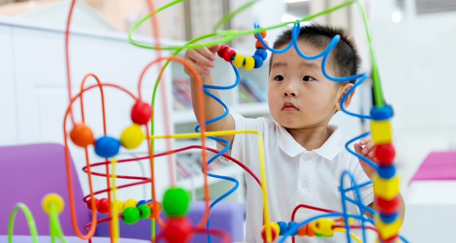Little boy working on a puzzle