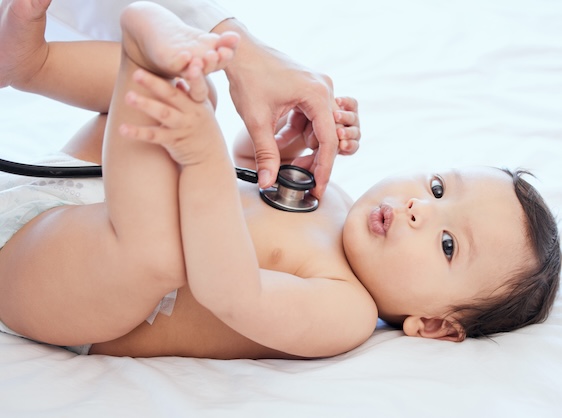 pediatrician listening to newborns heart