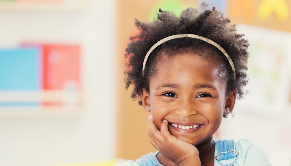 Portrait of adorable preschooler in her classroom